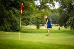  Girl putting on golf green.